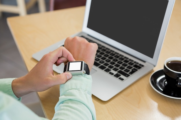 Man adjusting time on his smartwatch