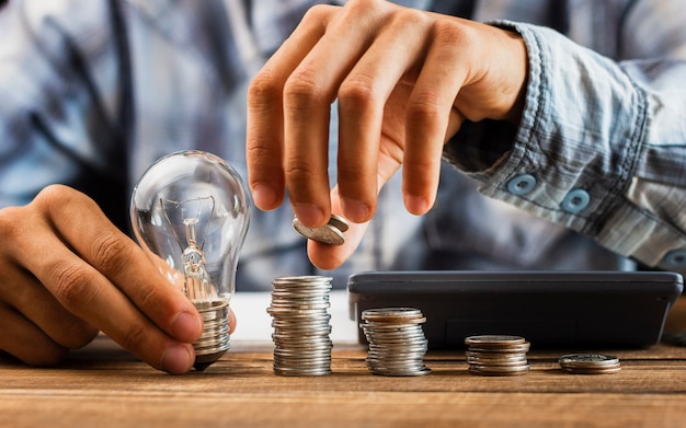 Man aligning saving coins on table