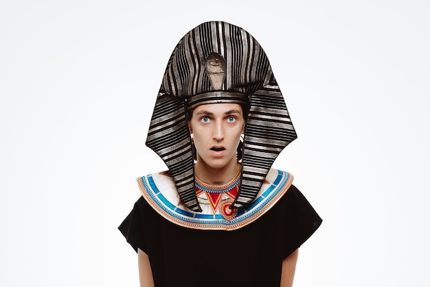 Man in ancient egyptian costume surprised and amazed on white