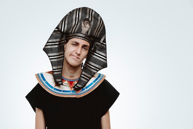 Man in ancient egyptian costume with skeptic expression on white