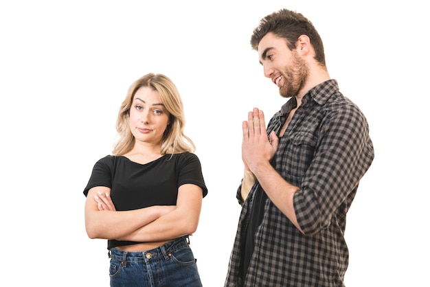 The man apologizes to a woman on the white background