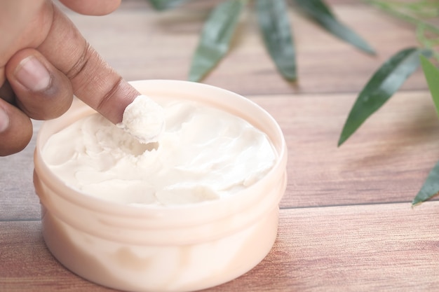 man applying beauty cream onto skin