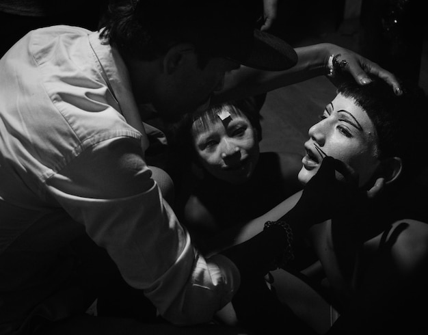 Man applying face paint to boy in room