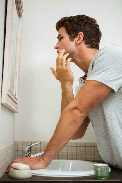 Man applying moisturizer on his face