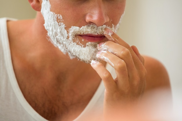 Man applying shaving foam