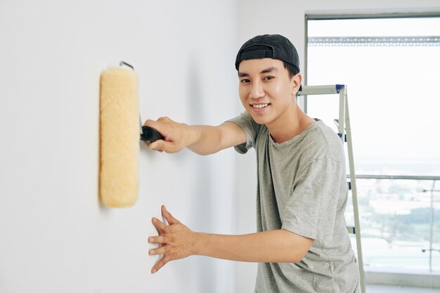 Man applying white paint