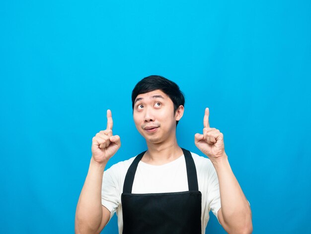 Man apron gesture point finger up at copy space