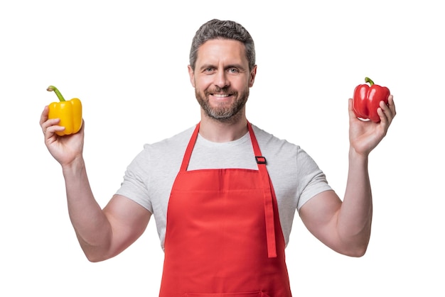 Man in apron with sweet pepper vegetable isolated on white