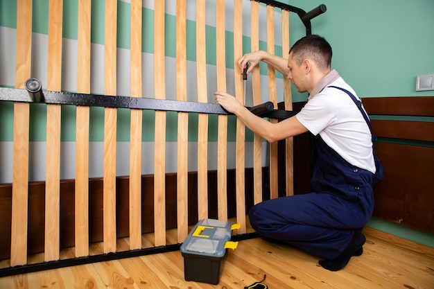 Photo man assembling sofa furniture at home