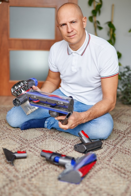 Man assembling a vacuum cleaner at home