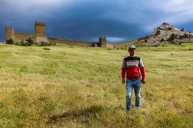 A man on the background of a fortress mountain and an ancient Genoese fortress Sudak Crimea