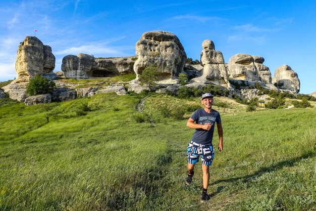 A man on the background of a picturesque view of the Bakhchisarai sphinxes Bakhchisarai May 2021