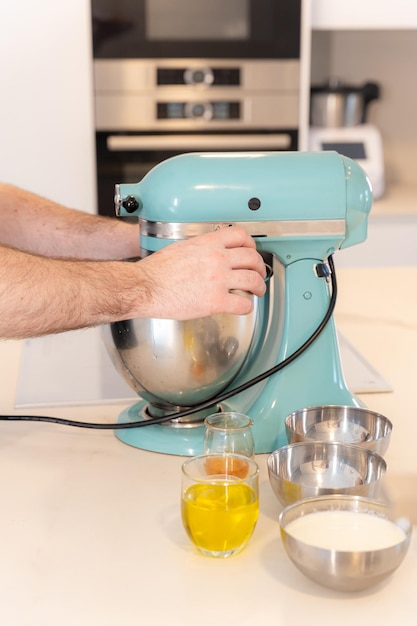 A man baker cooking a red velvet cake at home preparing the cake in the kitchen robot work at home