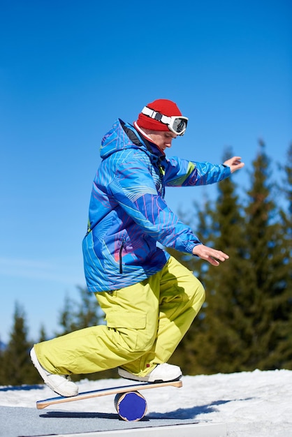 Man on the balance trainer with roller for snowboard at\
mountains