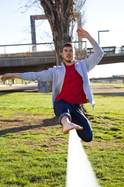 "Man balancing on handrail"