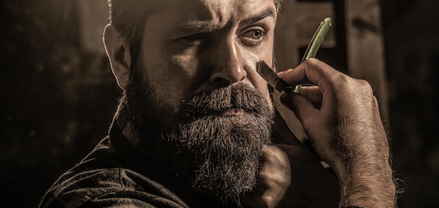 Man in barbershop. Vintage straight razor. Mens haircut.