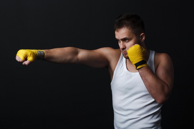 Man bare knuckle fighter stand at black background