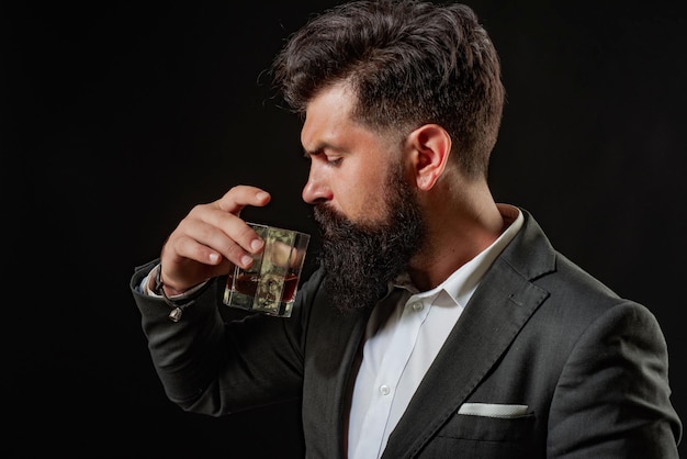 Man bartender holding glass of whisky tasting and degustation\
concept retro vintage man with whiskey or scotch