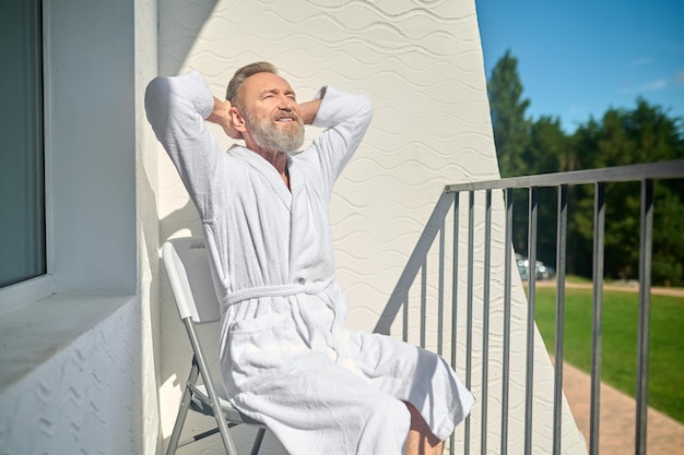 Man basking in the warmth of the morning sun