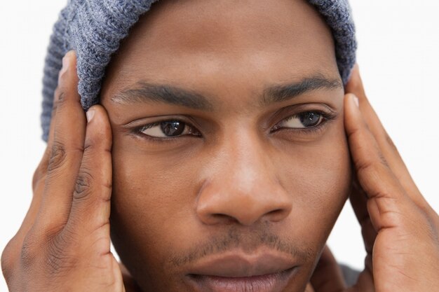 Man in beanie hat looking unhappy