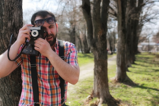 Man beard suspender tree park sunglasses