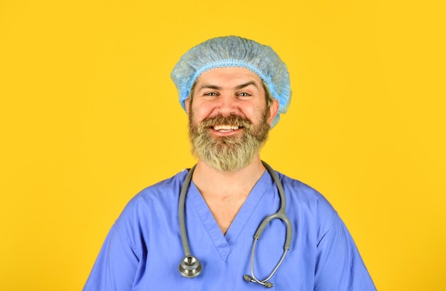 Man bearded doctor wear uniform cap Hipster work at hospital Health care Doctor occupation Medical insurance Incubation period Doctor ready to help Diagnosis concept Global health emergency