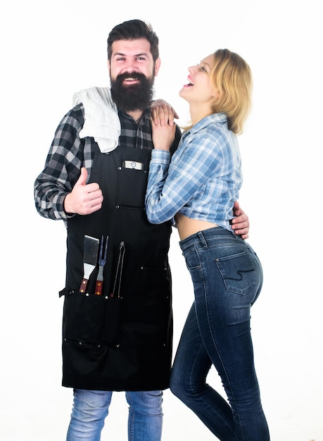 Man bearded hipster and girl Preparation culinary Couple in love hold kitchen utensils Tools for roasting Picnic barbecue food cooking recipe Family weekend Recipe requires a lot of loving