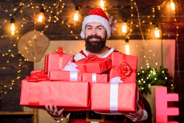 Man bearded santa celebrate christmas with presents May your home be filled with all joys of season New year celebration Santa claus hold many gifts Celebrate with joy Celebrate winter holidays