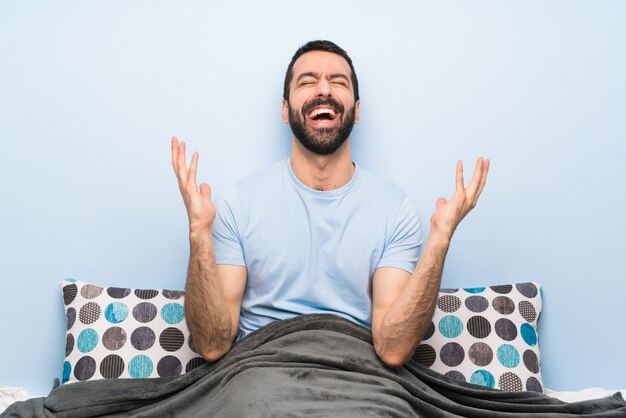 Man in bed smiling a lot