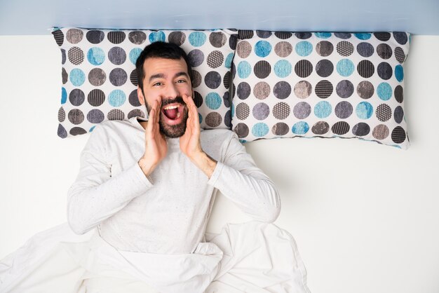 Man in bed in top view shouting and announcing something