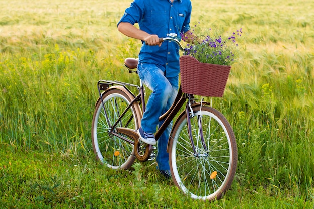 Man on a bicycle with flowers in a basket