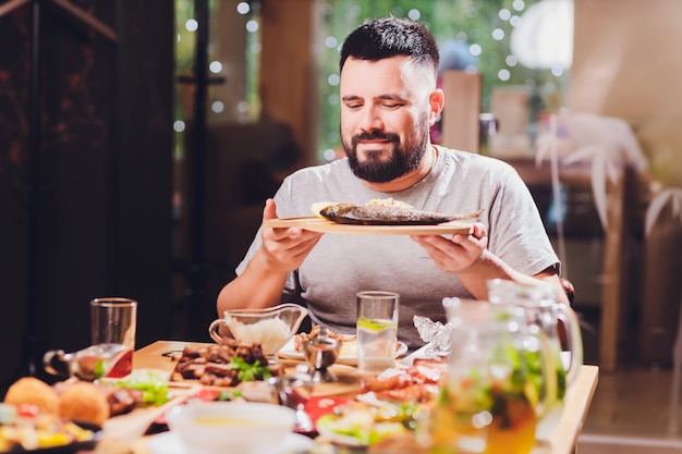 Man at the big table with food.