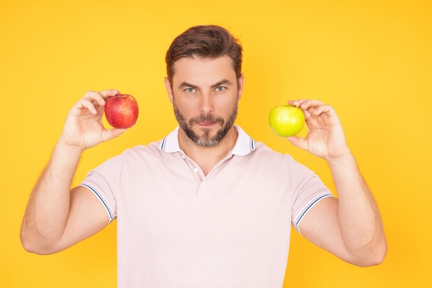 Man bitting tasty apple man eating apple studio portrait morning breakfast man with healthy teeth ho