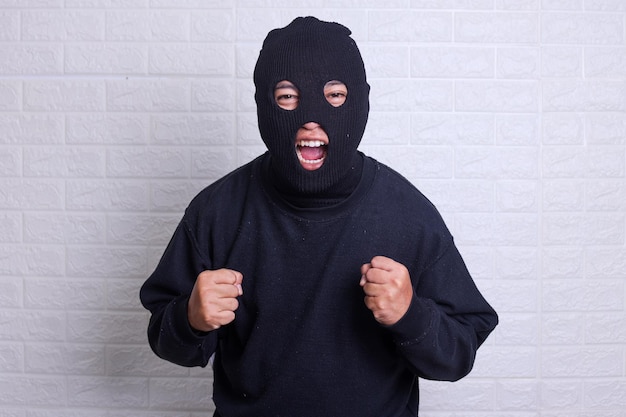 Man in black balaclava screaming