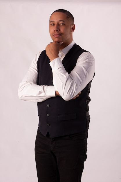 Man in black blazer, white shirt and black pants on a white background making body expressions.