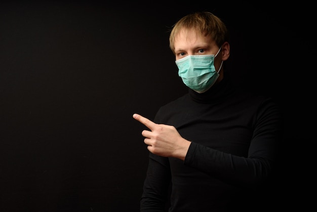 A man in black clothes on black in a protective mask is selling your product.