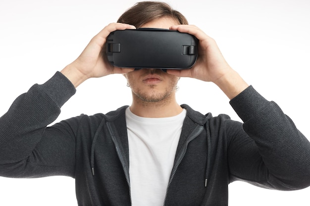 Man in black glasses of virtual reality in studio