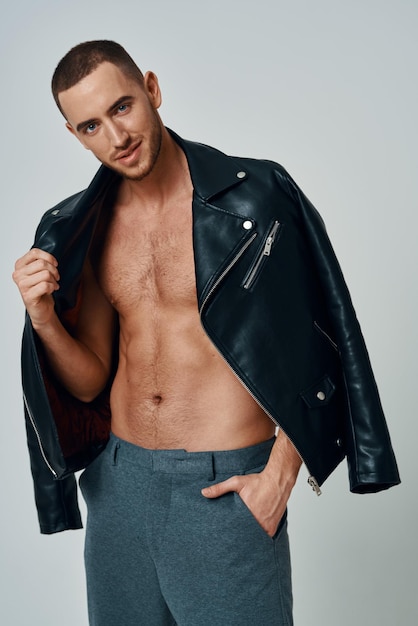 Man in black leather jacket topless posing modern style selfconfidence High quality photo