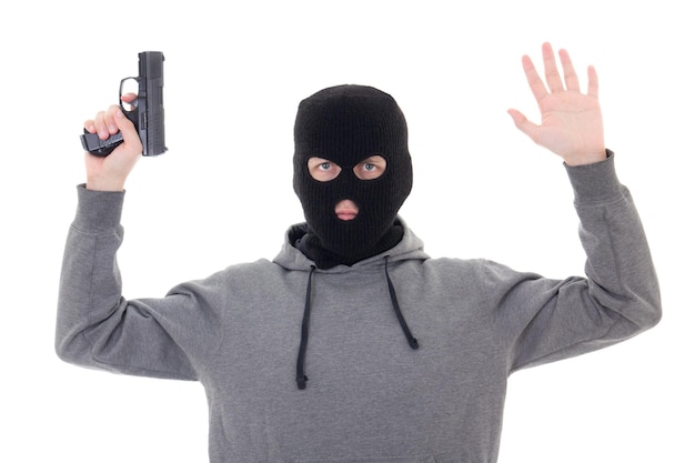 Man in black mask with gun holding hands up isolated on white background
