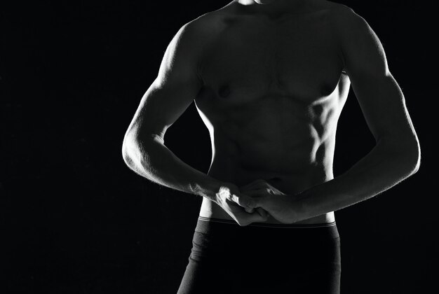 A man in black panties with a pumpedup body black and white
photo