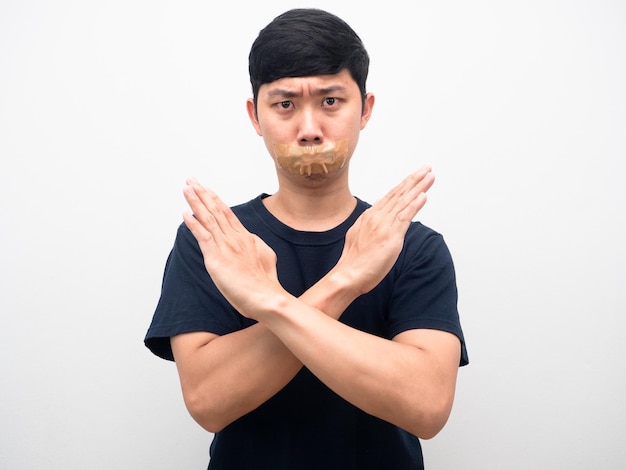 Man black shirt gesture cross arm with tape close mouth silence concept