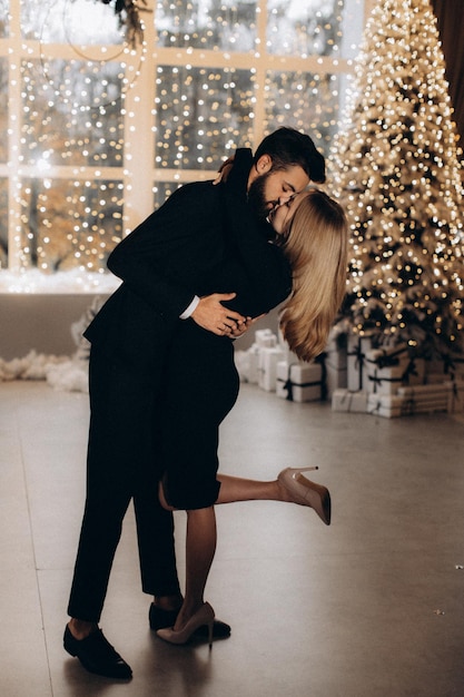 Man in black suit and woman in black dress celebrate the New Year