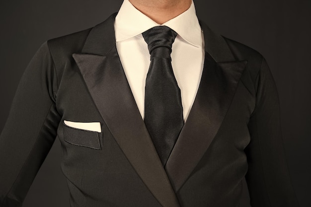 Man in a black tuxedo suit and white shirt