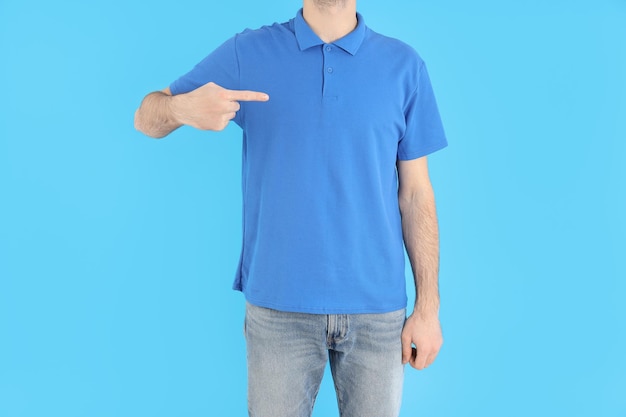 Man in blank blue polo on blue background