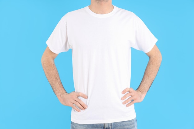 Man in blank white t-shirt on blue background