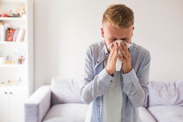 Photo man blowing nose with handkerchief