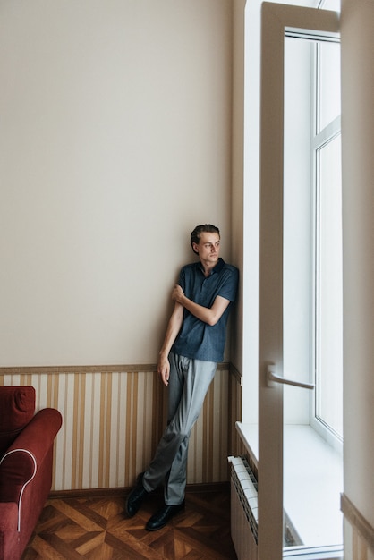 A man in a blue polo poses for menswear advertising. Shooting for men's clothing store