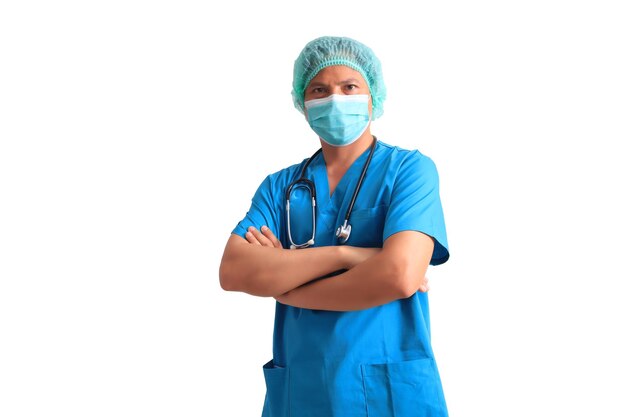 A man in a blue scrubs and a stethoscope stands with his arms crossed.