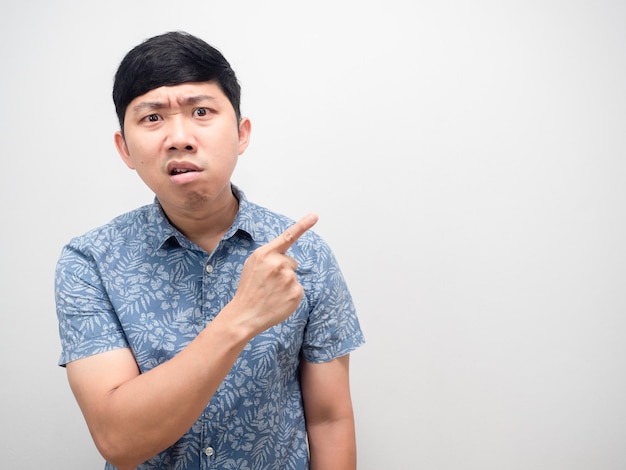 Man blue shirt angry face point finger at copy space isolated