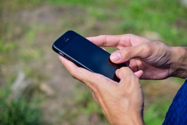 Man blue shirt are using smartphone by internet online